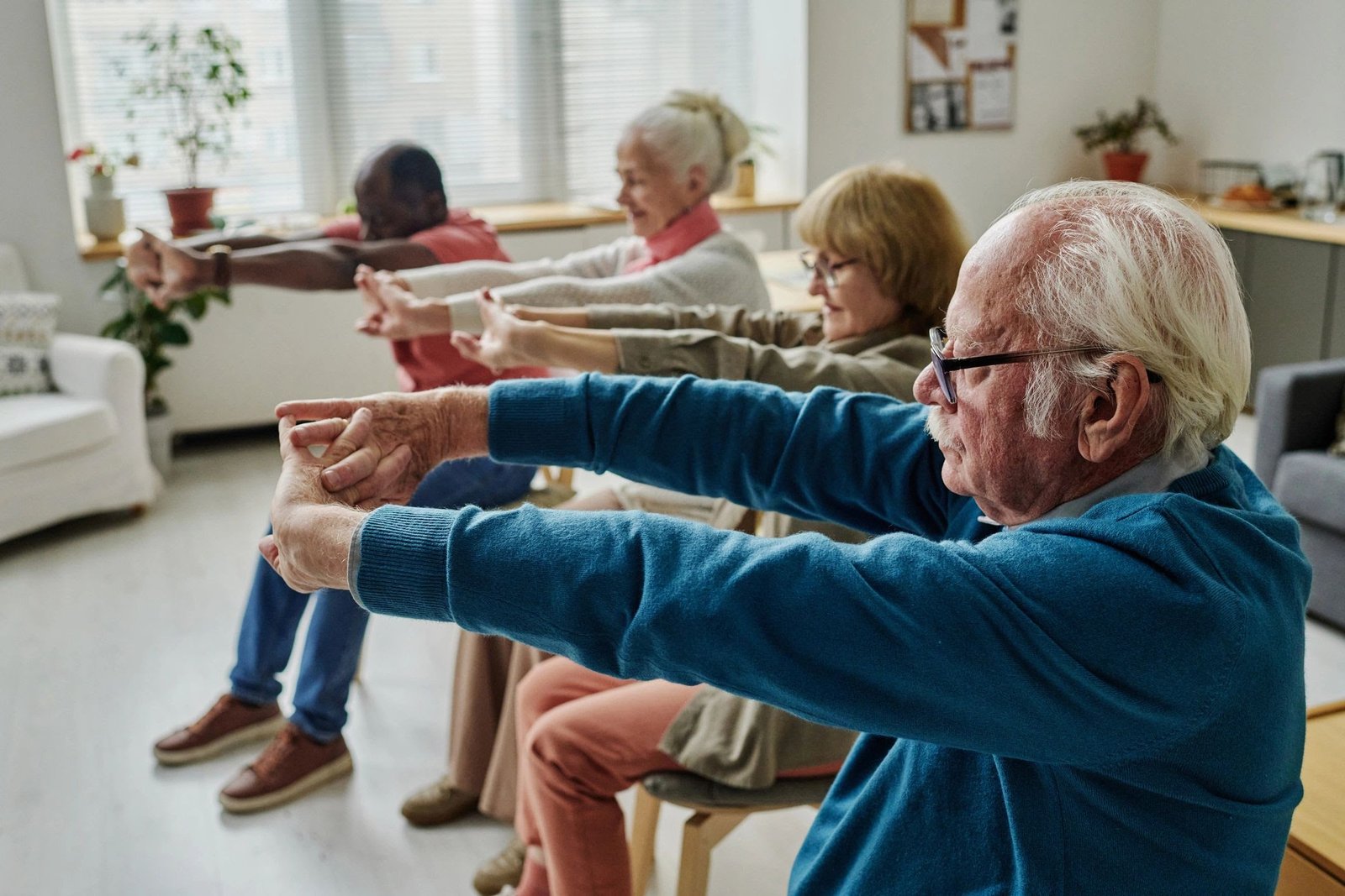 Older adults taking part in a gentle movement class together